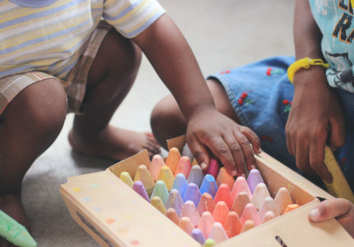children playing with crayons