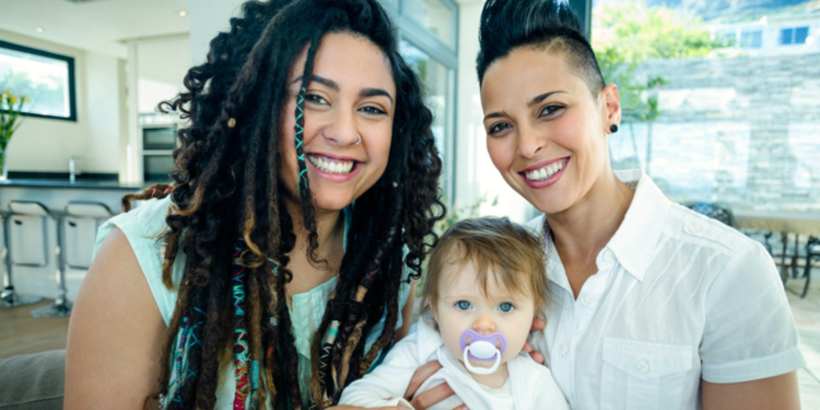 Adoptive LGTBQ couple with their child