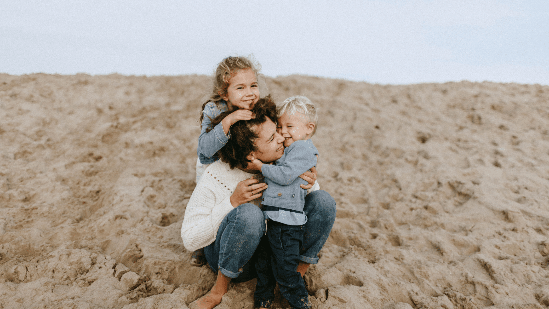 mother with two kids on the beach
