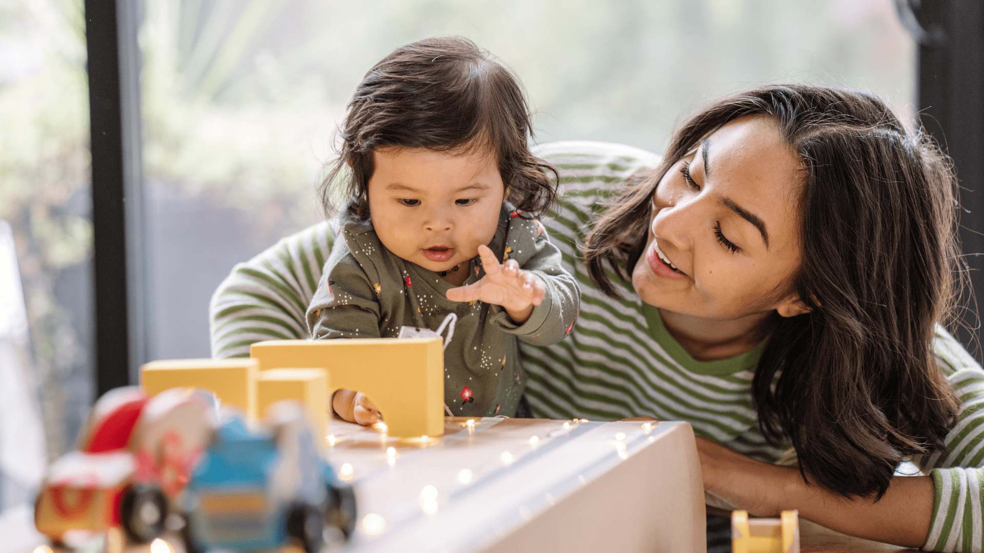 mother and toddler playing with toys