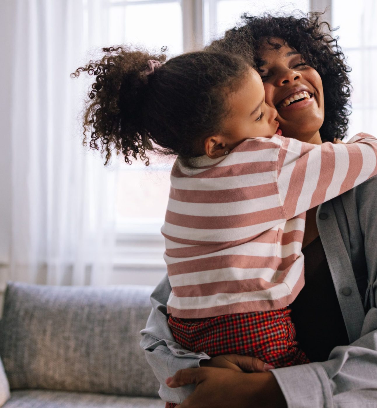 Dual heritage family of two, mother and her daughter, hugging each other with a lot of love.